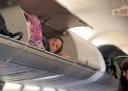 Wanita Cantik Ini Rebahan Santai di Bagasi Kabin Pesawat Bikin Penumpang Heran, Gimana Masuknya?