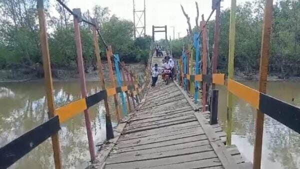 Nekat, Warga dan Pelajar di Kalsel Tetap Lintasi Jembatan Gantung meski Kondisi Miring